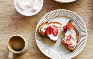 Plate of toast with spread and strawberries