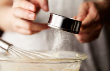 sprinkling powder into a baking bowl